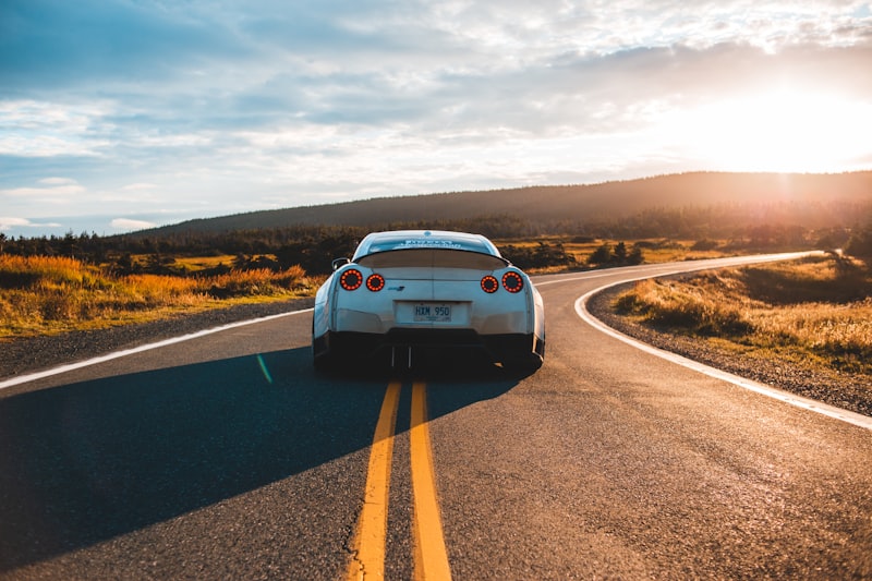 Car driving on the road at sunset