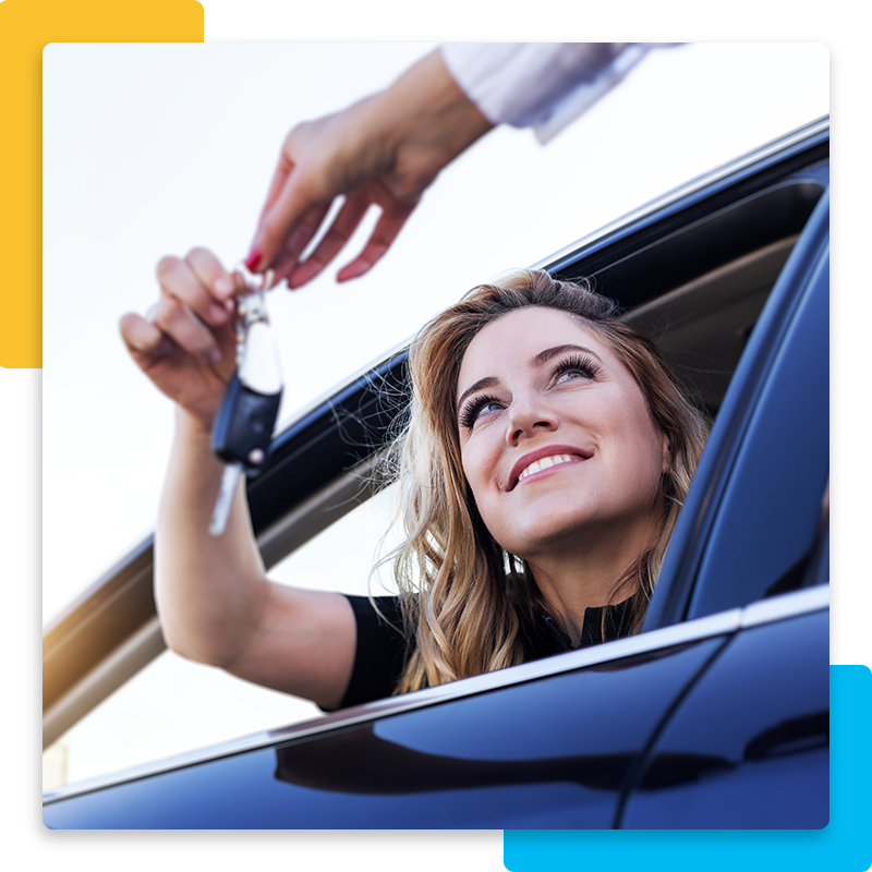 Woman smiling while holding car keys in her car